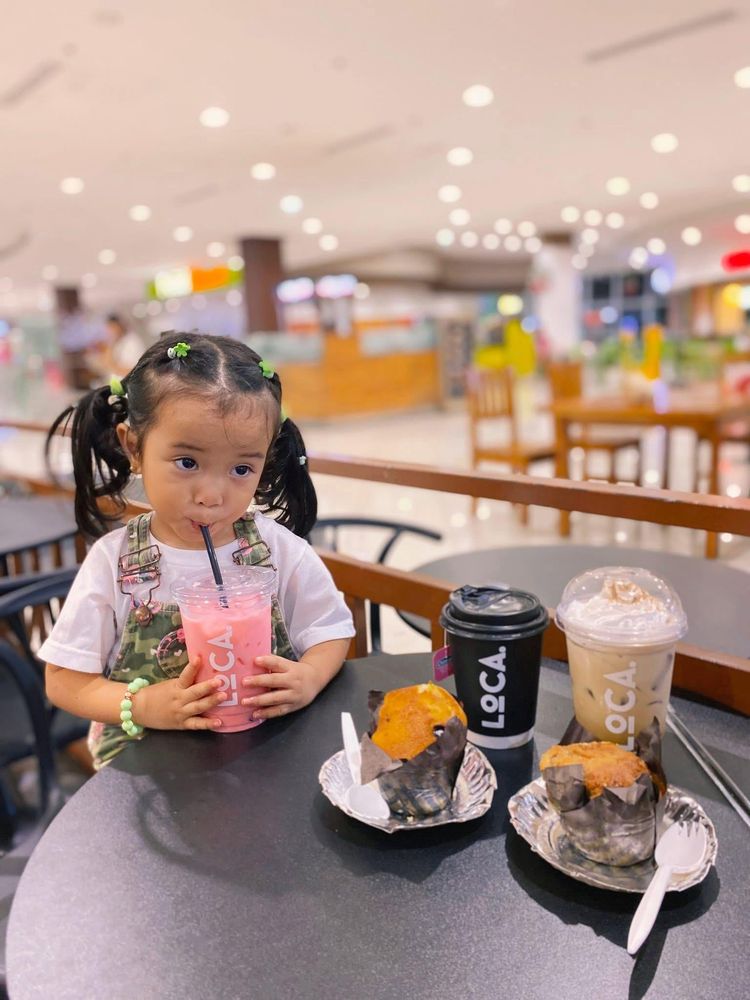 Little girl enjoying a drink at Loca
